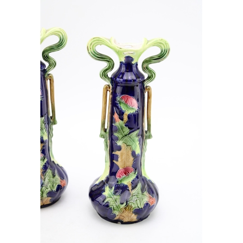 225 - A pair of Austrian Art Nouveau pottery vases, thistle design, by Josef Strnact, 23cm tall (2).