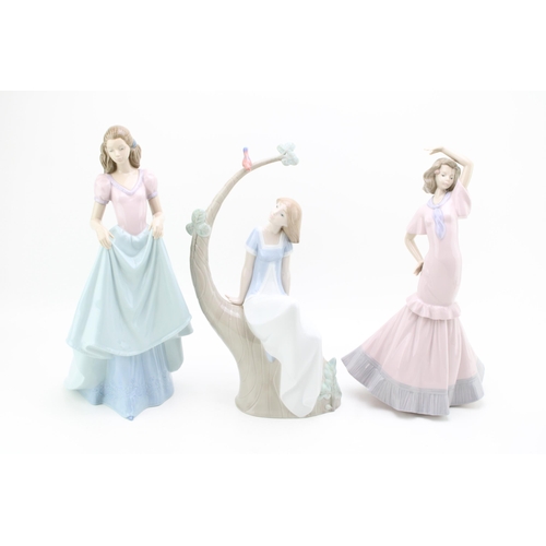 240 - Three large Nao figurines to include a girl sat on a tree with two others (3), tallest 34cm tall.