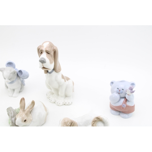 246 - A collection of Lladro animals to include a rabbit on branch, a beagle / hound, with Nao figures suc... 