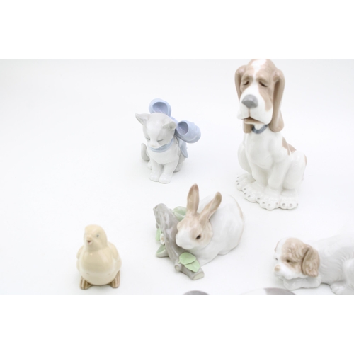 246 - A collection of Lladro animals to include a rabbit on branch, a beagle / hound, with Nao figures suc... 