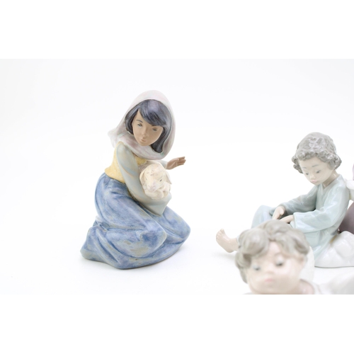 247 - Lladro figures to include a Angel Care 5727, a cherub / angel, a similar item and girl with lost lam... 