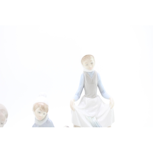 248 - Lladro figures to include a girl with goose, an angel, a boy with sheep and a girl with hare (4).