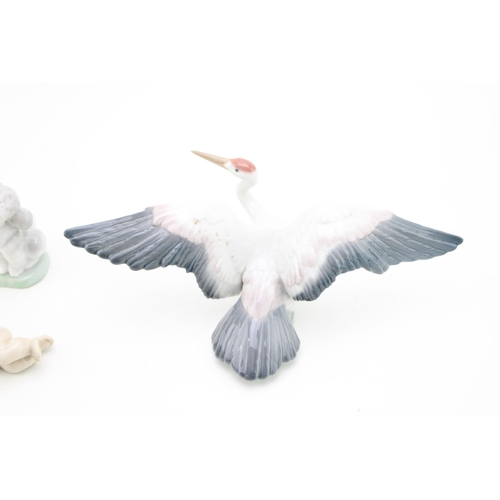 253 - Lladro animals to include a Landing Crane 1600, a Lladro dog and a Cherub (3).