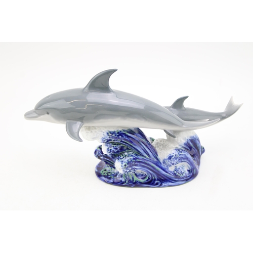 254 - Lladro pair of Dolphins on naturalistic base, 28cm wide.