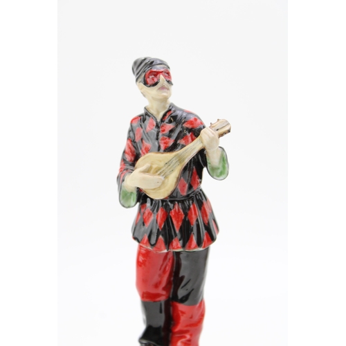 268 - A ceramic Harlequin figure playing the mandolin on marble base,  possibly Doulton or similar. Height... 