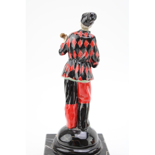 268 - A ceramic Harlequin figure playing the mandolin on marble base,  possibly Doulton or similar. Height... 