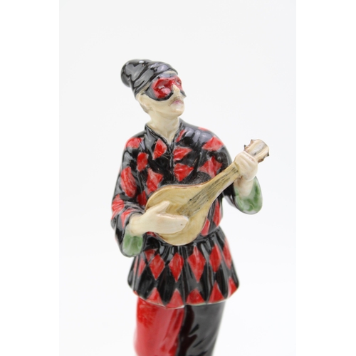 268 - A ceramic Harlequin figure playing the mandolin on marble base,  possibly Doulton or similar. Height... 