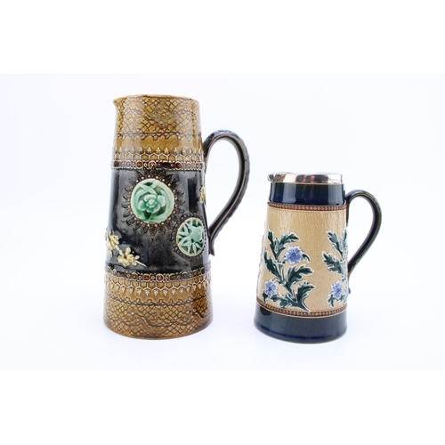 279 - Two Doulton Lambeth jugs, one with silver rim, 14cm tall, Sheffield 1899, with a taller example, 19.... 