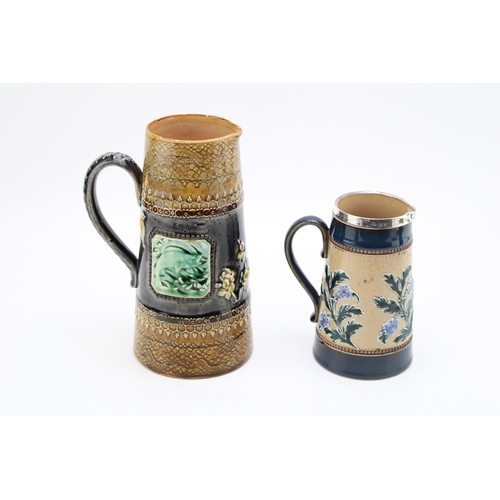 279 - Two Doulton Lambeth jugs, one with silver rim, 14cm tall, Sheffield 1899, with a taller example, 19.... 