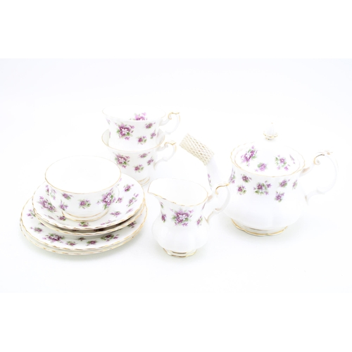 306 - Royal Albert tea for two set in the Sweet Violets pattern to include a small teapot, two cups, two s... 