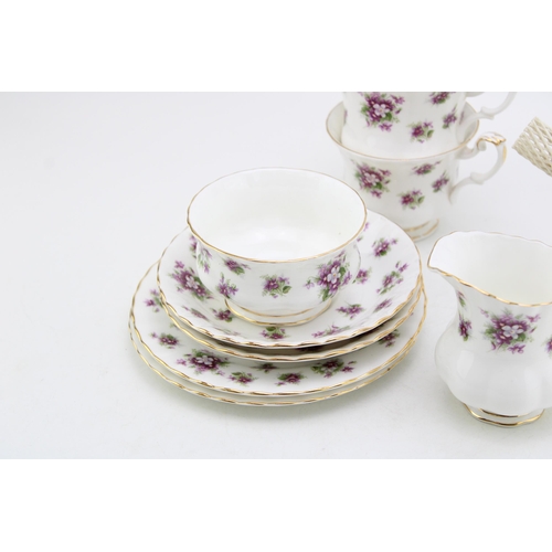 306 - Royal Albert tea for two set in the Sweet Violets pattern to include a small teapot, two cups, two s... 