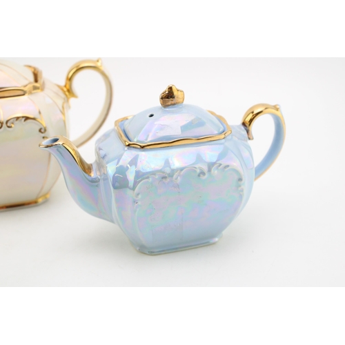 310 - Sadler teapot in cream together with a small blue Sadler example (2).