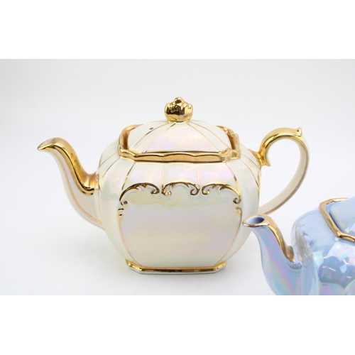 310 - Sadler teapot in cream together with a small blue Sadler example (2).