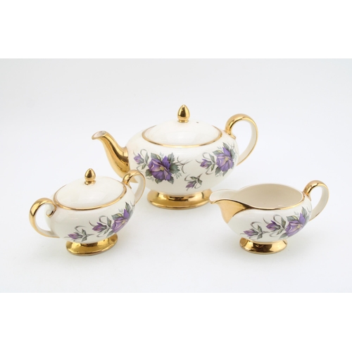 311 - Sadler purple flower tea set to include a teapot, lidded sugar and milk jug (3).