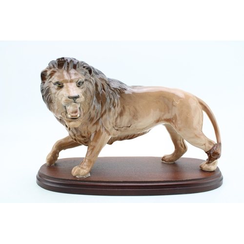 32 - Beswick Lion mounted on wooden base.