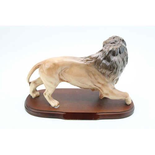 32 - Beswick Lion mounted on wooden base.