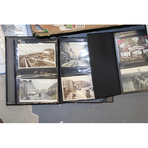 418 - A large and varied collection of antique and vintage postcards to include four folders together with... 