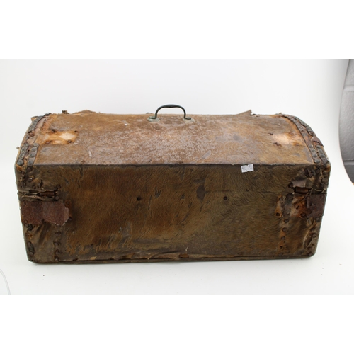 432 - An early c19th hide covered wooden travel trunk for restoration