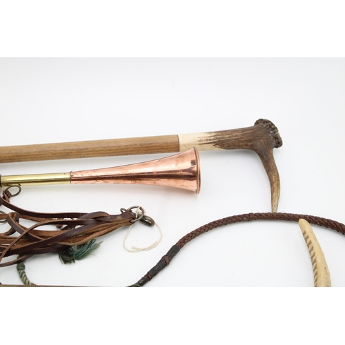 445 - A collection of Hunting accessories to include  a leather game hanger, two stag antler riding crops,... 