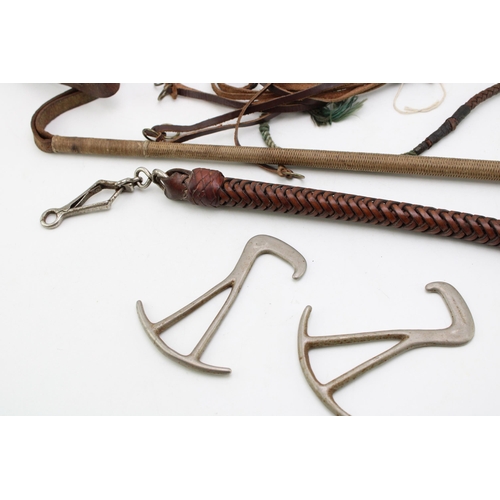 445 - A collection of Hunting accessories to include  a leather game hanger, two stag antler riding crops,... 