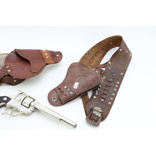 492 - Two vintage toy gun holsters together with a BCM Frontier cap gun. (2)