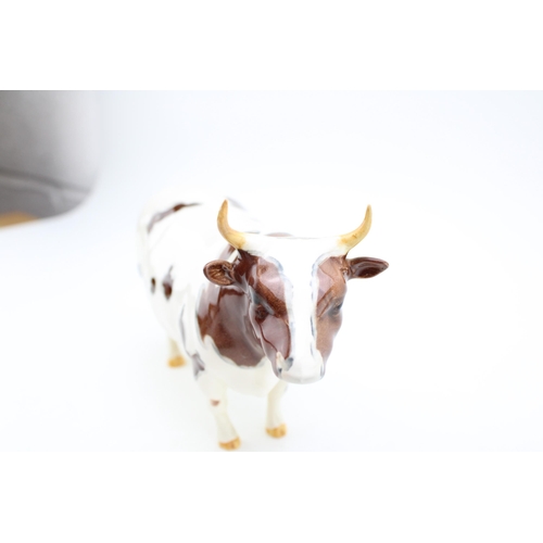 51 - Beswick Ayrshire cattle family to include Ayrshire Bull (restored right horn), Ayrshire Cow and an A... 