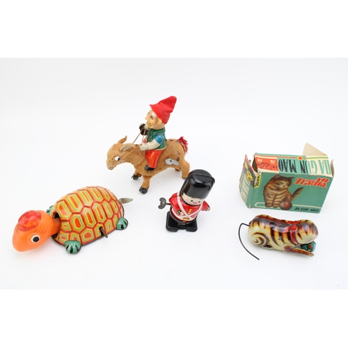 513 - A collection of clockwork tinplate toys, Made in Japan to include, 'Elf on Donkey' (working) Soldier... 