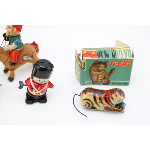 513 - A collection of clockwork tinplate toys, Made in Japan to include, 'Elf on Donkey' (working) Soldier... 