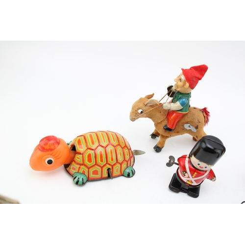 513 - A collection of clockwork tinplate toys, Made in Japan to include, 'Elf on Donkey' (working) Soldier... 