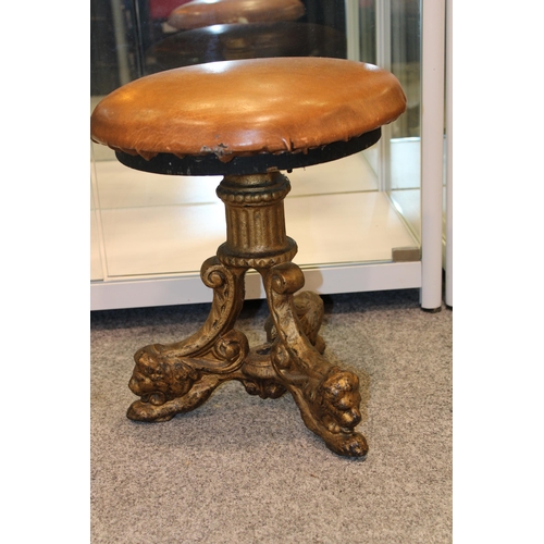 537 - A cast iron Victorian pub stool with lion decoration to three legs. Stamped Arch Stewart and Co Glas... 