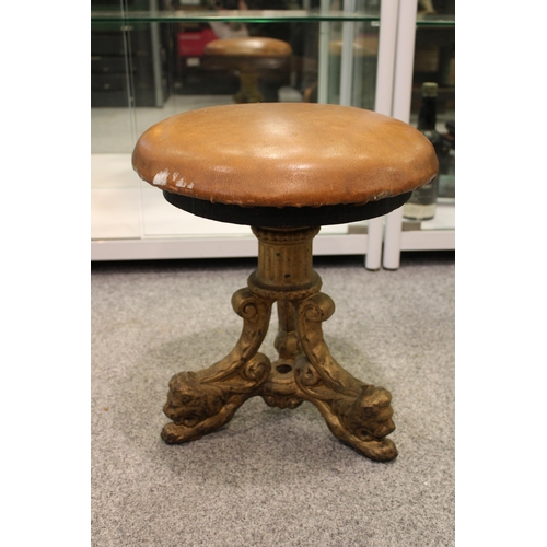 537 - A cast iron Victorian pub stool with lion decoration to three legs. Stamped Arch Stewart and Co Glas... 