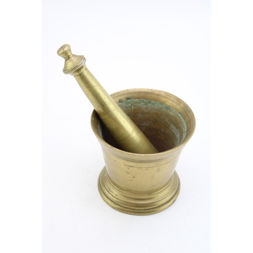 541 - A late 19th century brass apothecary's mortar and pestle (2), pestle 16cm long.