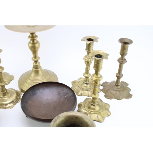 543 - A collection of c18th & c19th brass candlesticks and other brass items including mortars, a stand an... 