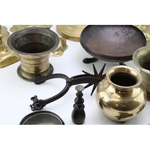 543 - A collection of c18th & c19th brass candlesticks and other brass items including mortars, a stand an... 