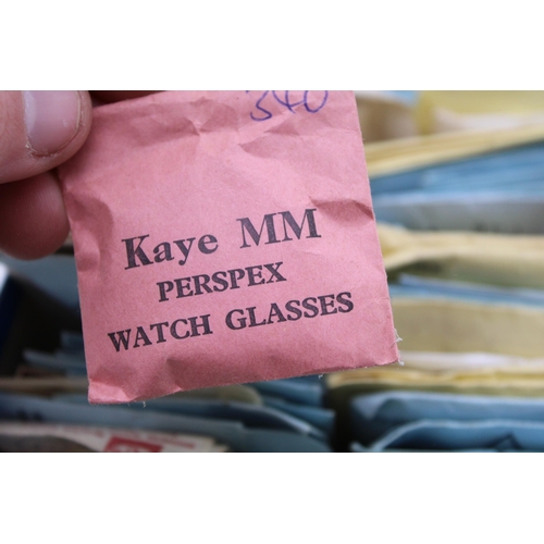 562 - A large collection of various sized watch glasses.