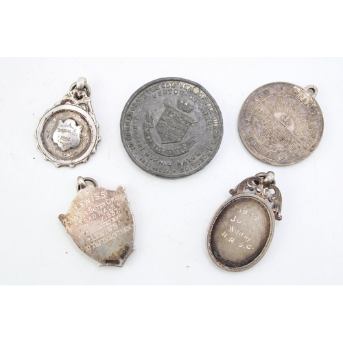 584 - A collection of silver fobs (27.5g)  together with a white metal token and a pewter commemorative to... 