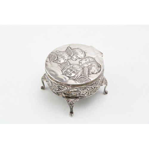 602 - Silver four legged trinket box, Reynold's Angels design, Birmingham 1905, 8cm diameter.