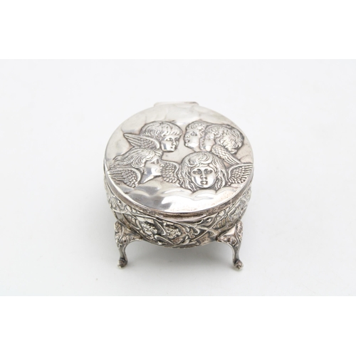 602 - Silver four legged trinket box, Reynold's Angels design, Birmingham 1905, 8cm diameter.