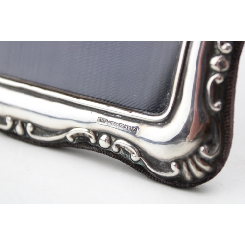 604 - Silver easel back photoframe, ornate edges, Birmingham 2002, 18cm tall.