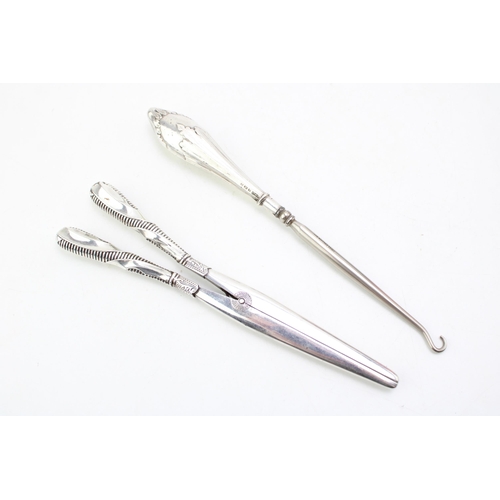 607 - A pair of silver handled glove stretchers with a button hook, one Birmingham 1914, the other 1922 (3... 