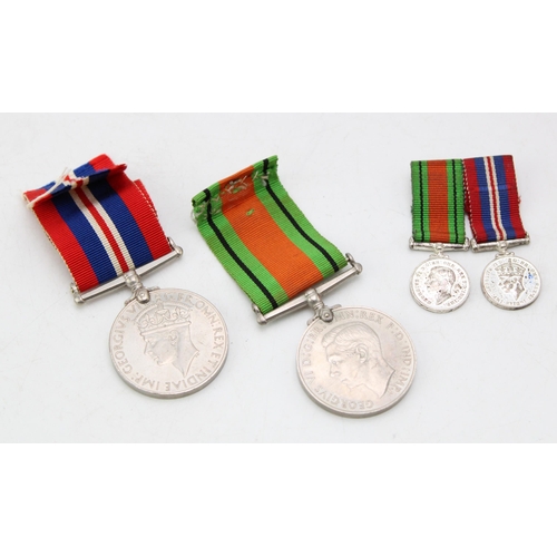 615 - A pair of World War Two medals with pair of matching miniatures (4).