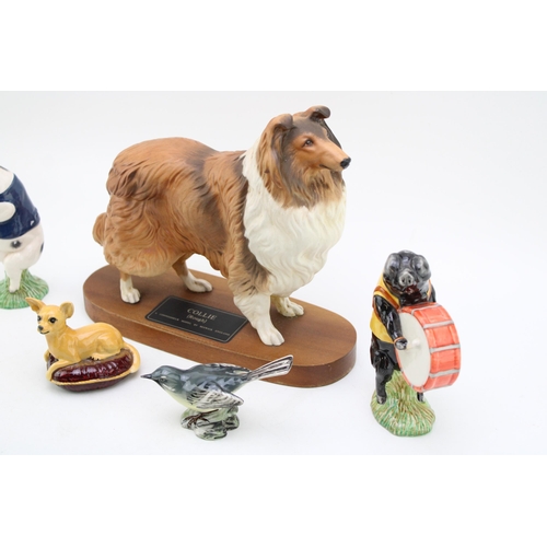 62 - Beswick to include a large Rough Collie on a wooden base, pig band figures Andrew and Michael, a whi... 