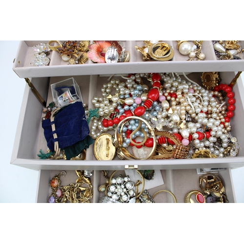 623 - A mixed collection of costume jewellery to include brooches, rings, necklaces and similar items in a... 