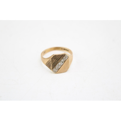 658 - A 9ct gold signet ring, the textured setting with five white stones, size Q, 3.9g.