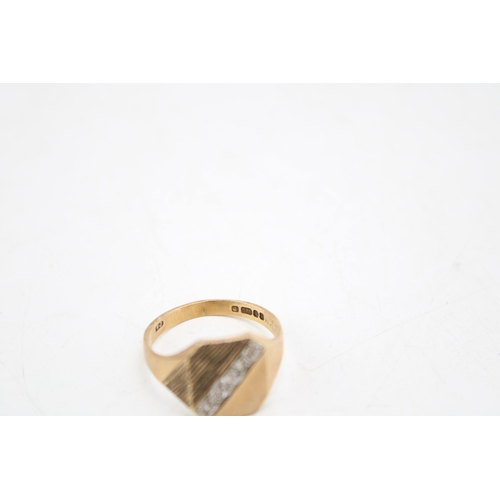 658 - A 9ct gold signet ring, the textured setting with five white stones, size Q, 3.9g.