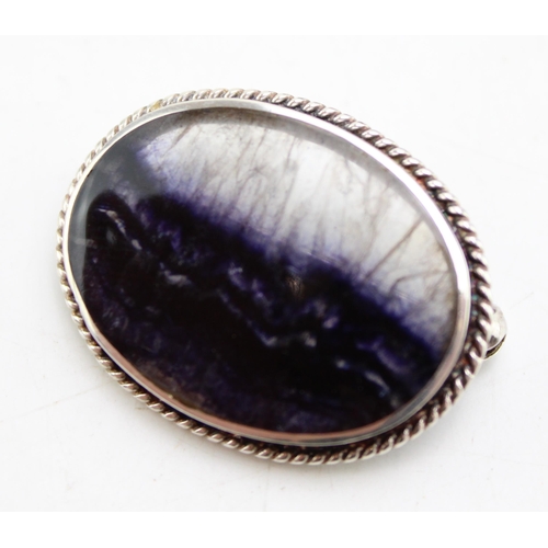 669 - A Blue John brooch with silver mount. Height 3cm.