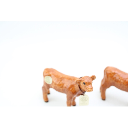 88 - Four Border Fine Arts pottery calf figures of two different breeds (4).