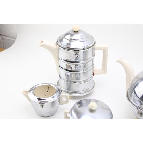 104 - A vintage ceramic and chrome metal tea and coffee set. Height 22xm.