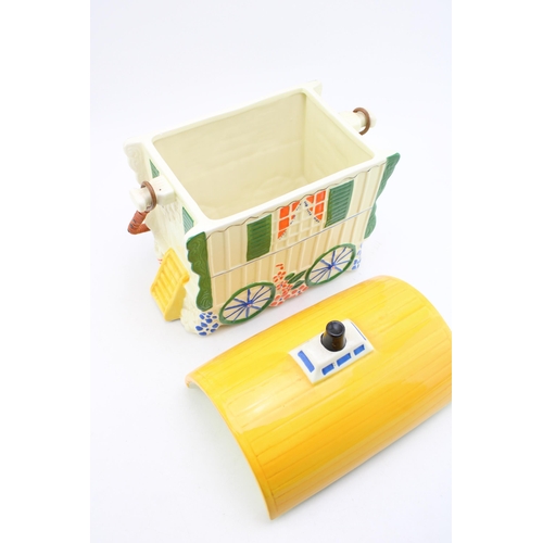 106 - An Old Romany Bone China ceramic biscuit barrel in the form of a Bow Top Caravan. Height 39cm with h... 