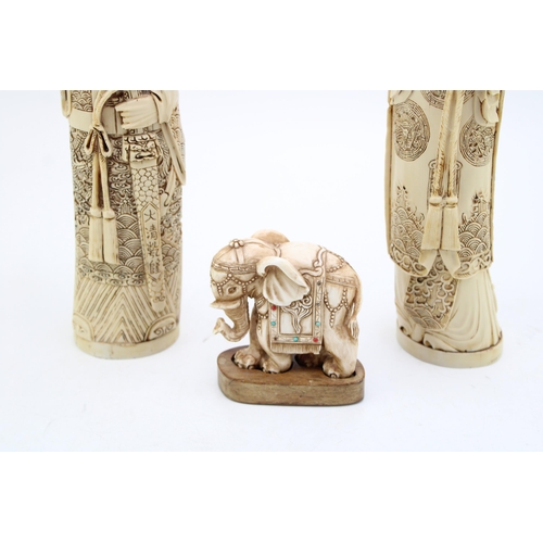 108 - A pair of faux ivory / resin figures together with an elephant mounted on wooden plinth. Height 29cm... 